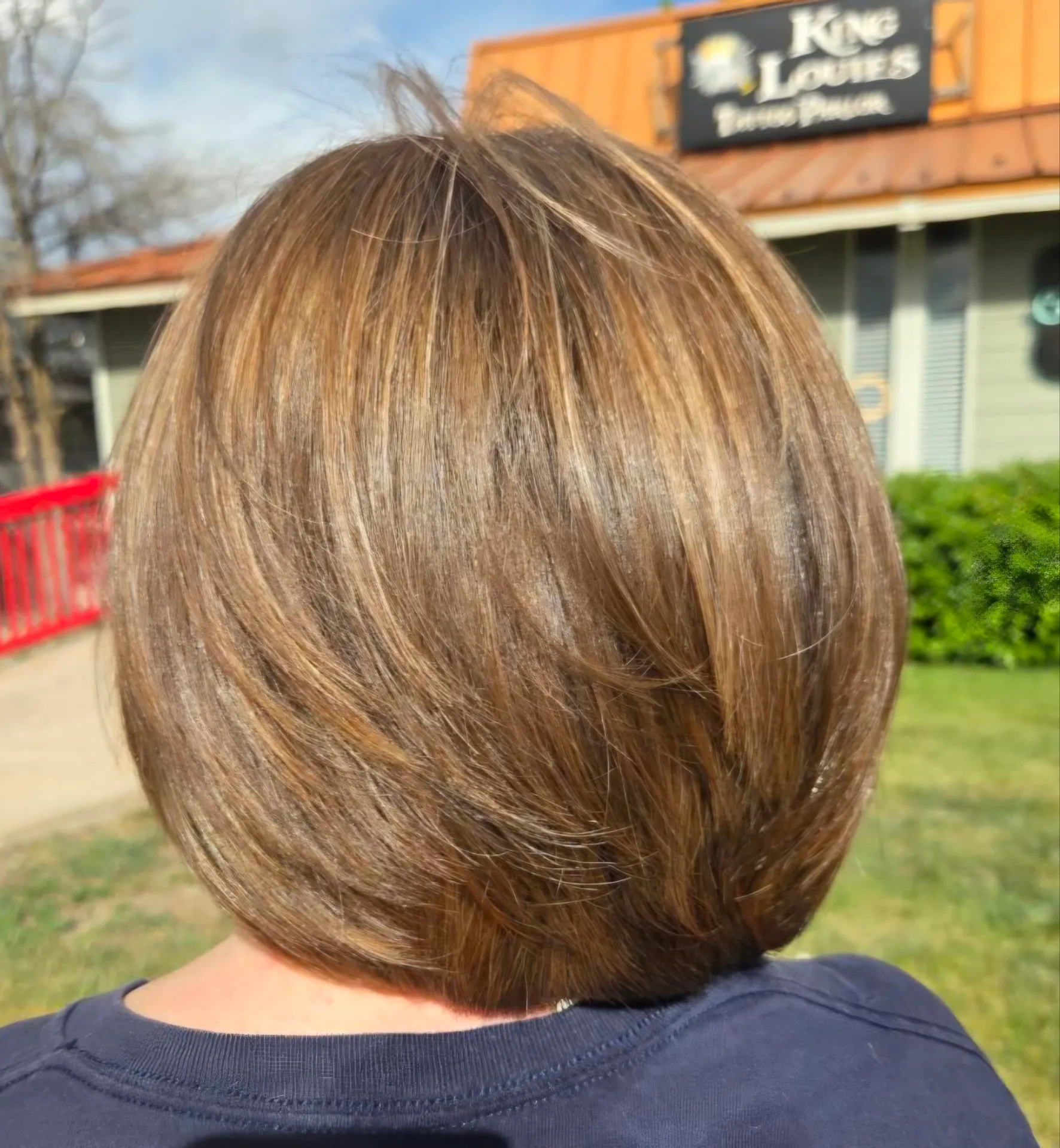 Dimensional brunette stacked bob with caramel highlights