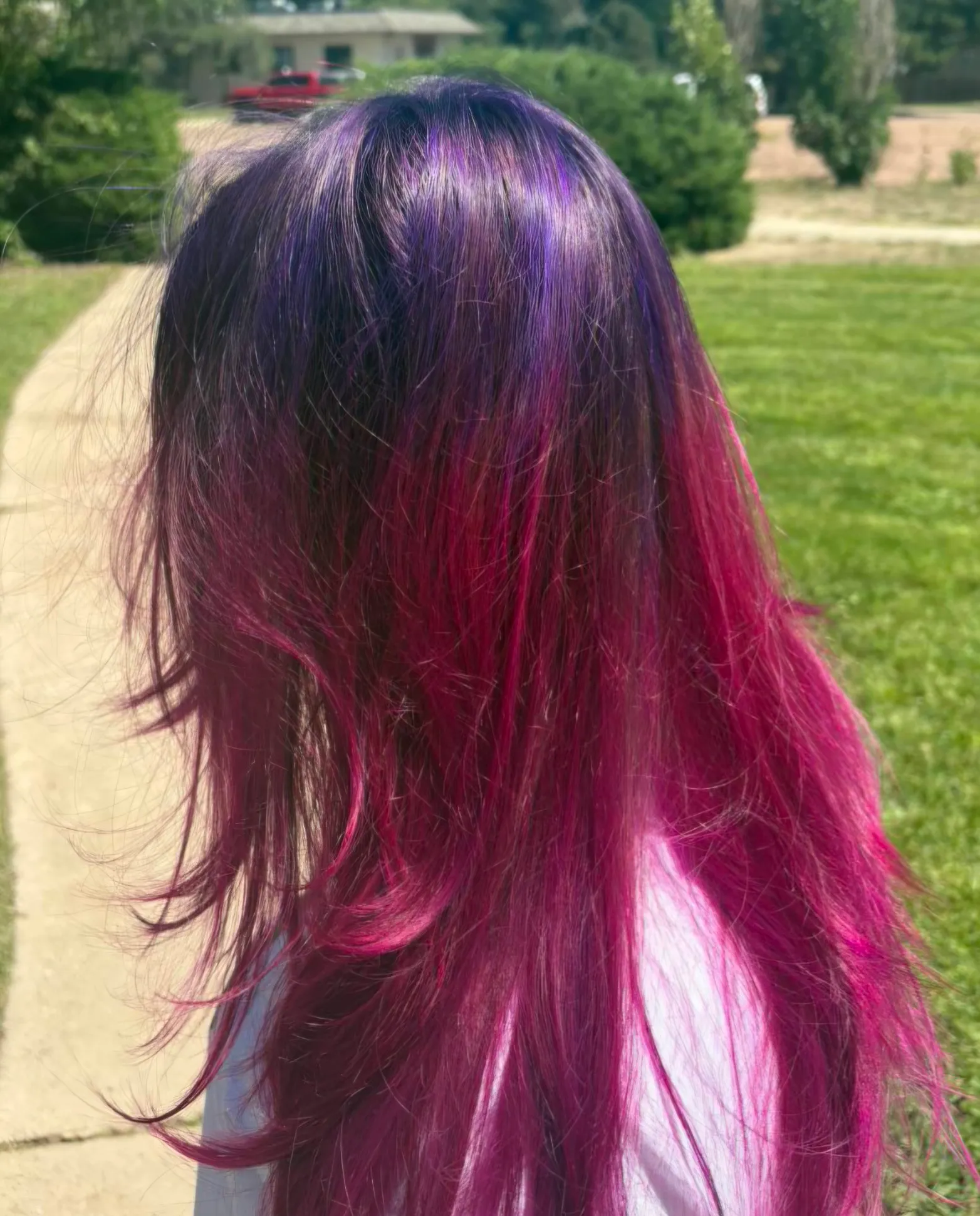 Magenta and violet berry colour melt flowing down long hair