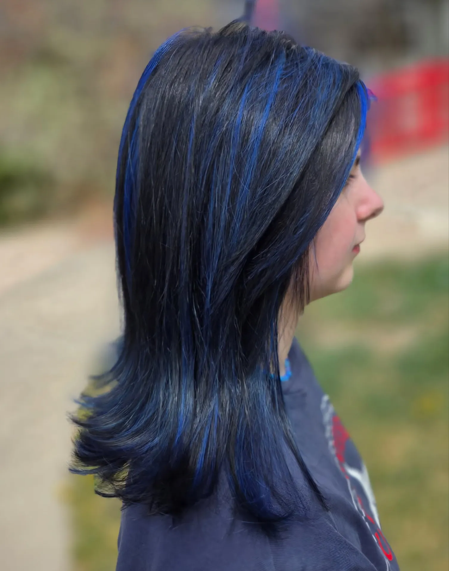 Jet black hair with electric blue ribbons and a soft flip
