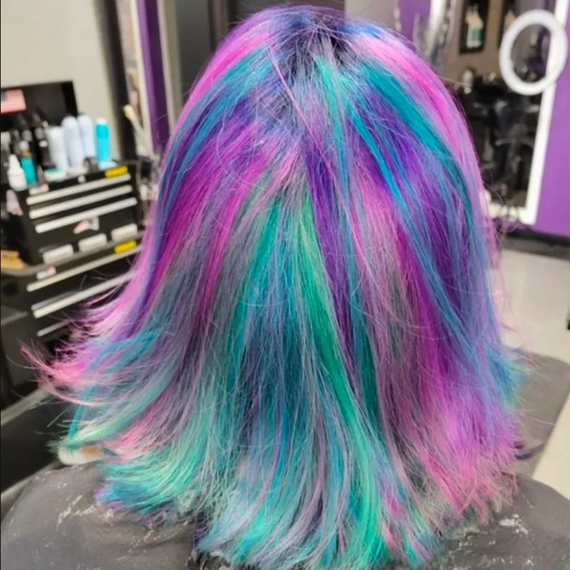 Iridescent teal, violet and pink oil-slick colour melt on layered hair