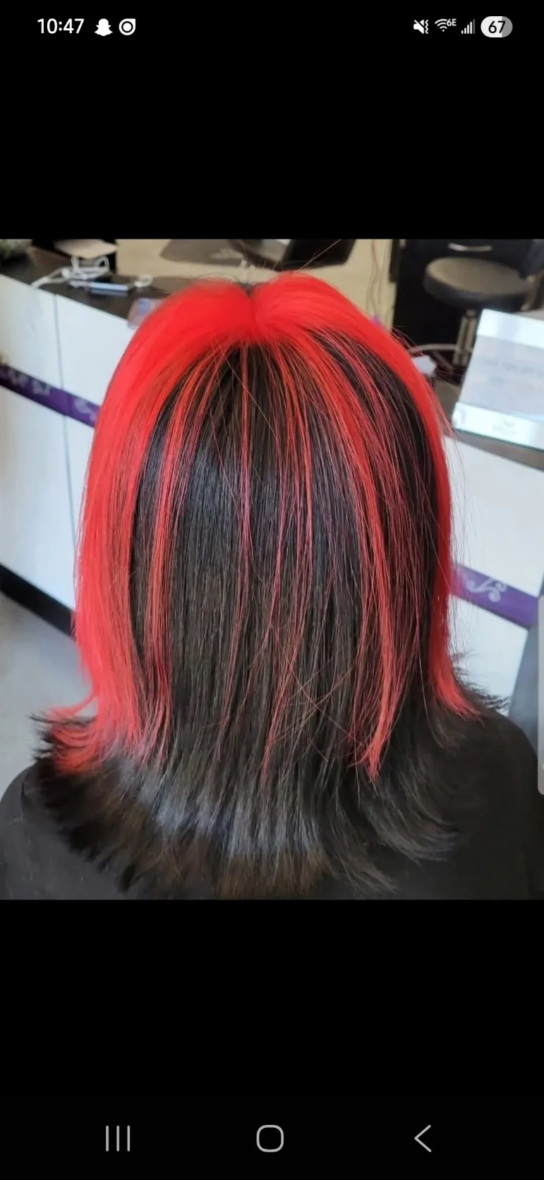 Bold red money-piece framing black hair