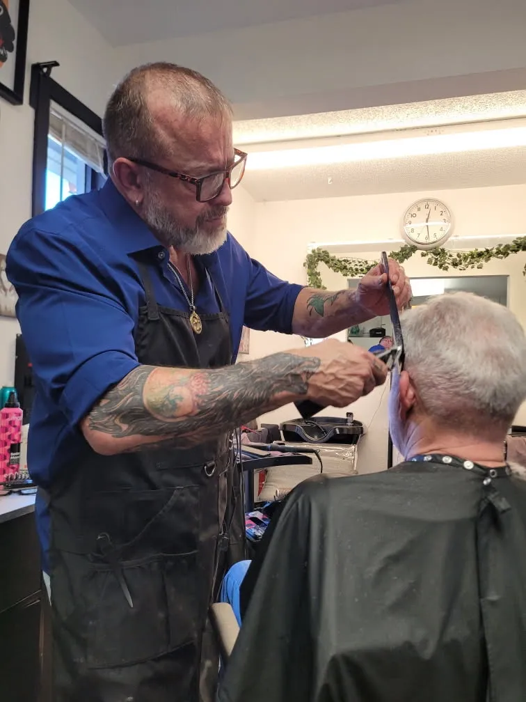 Rob Maggart cutting a client's hair in his Colorado Springs studio